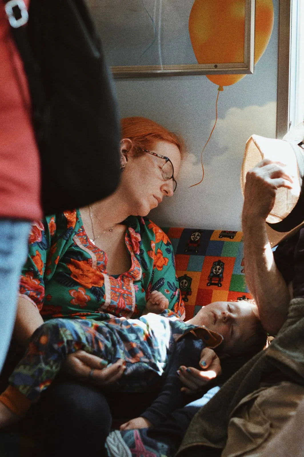 A heartfelt scene of a family resting on a train in Kyoto.