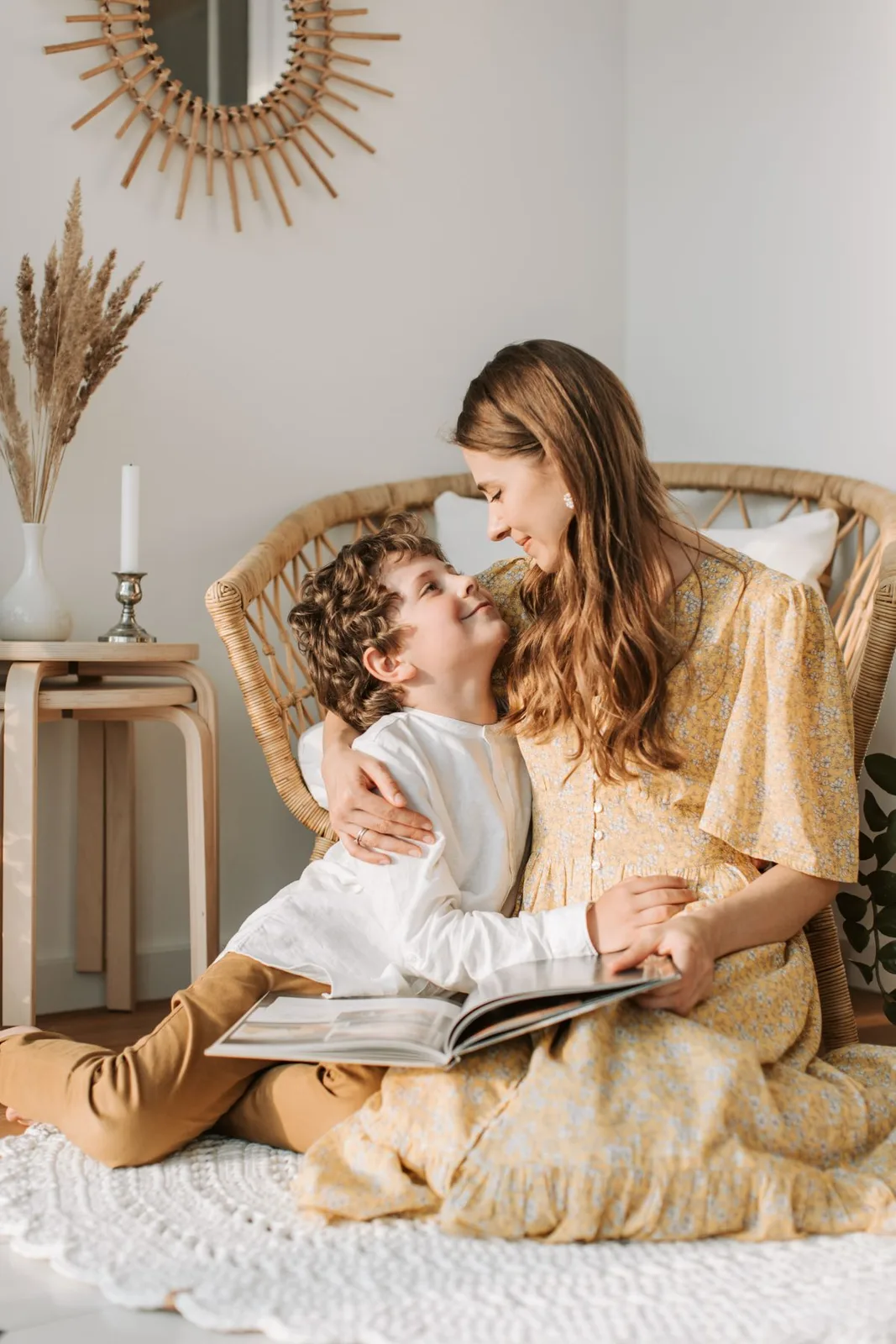 A mother and son sharing a warm moment at home with a cozy interior.
