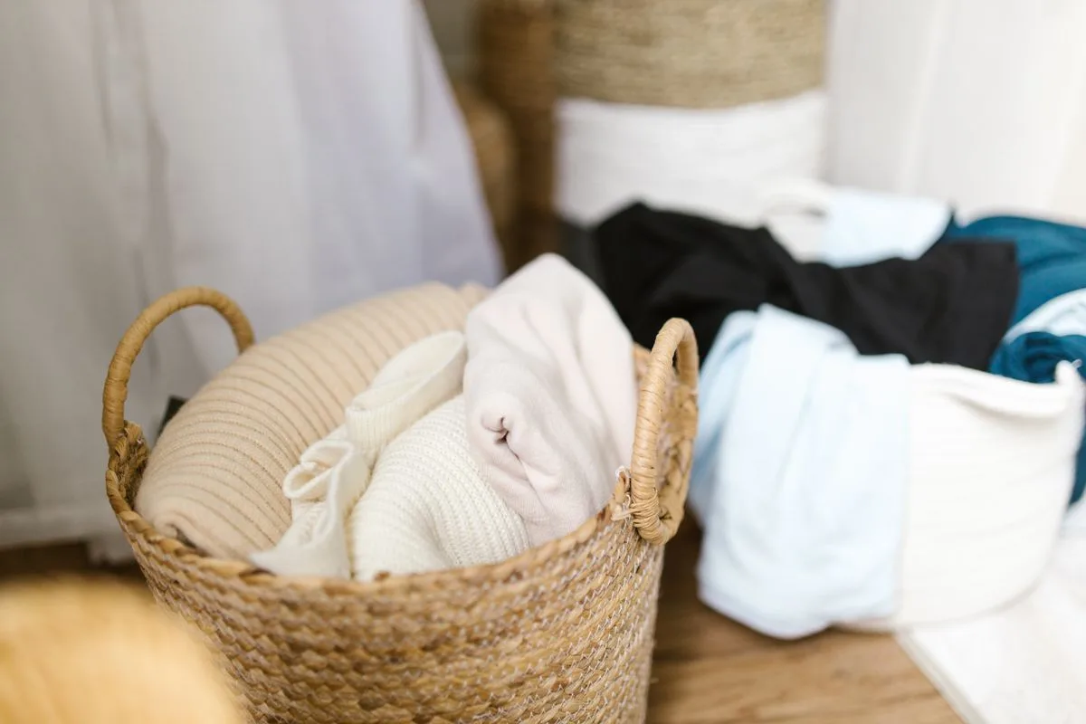 Clothes arranged in two woven laundry baskets.