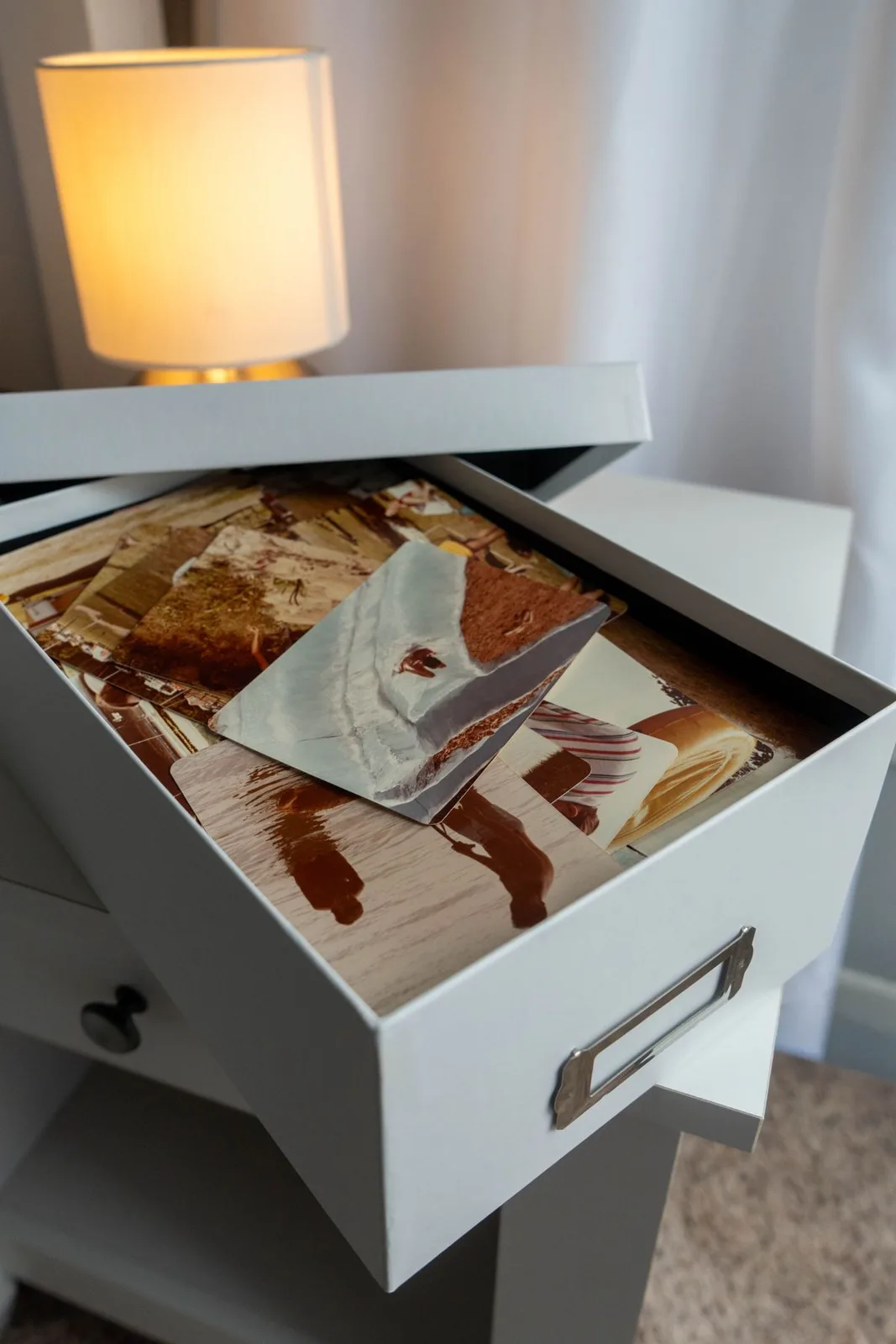 Open box filled with vintage family photos.