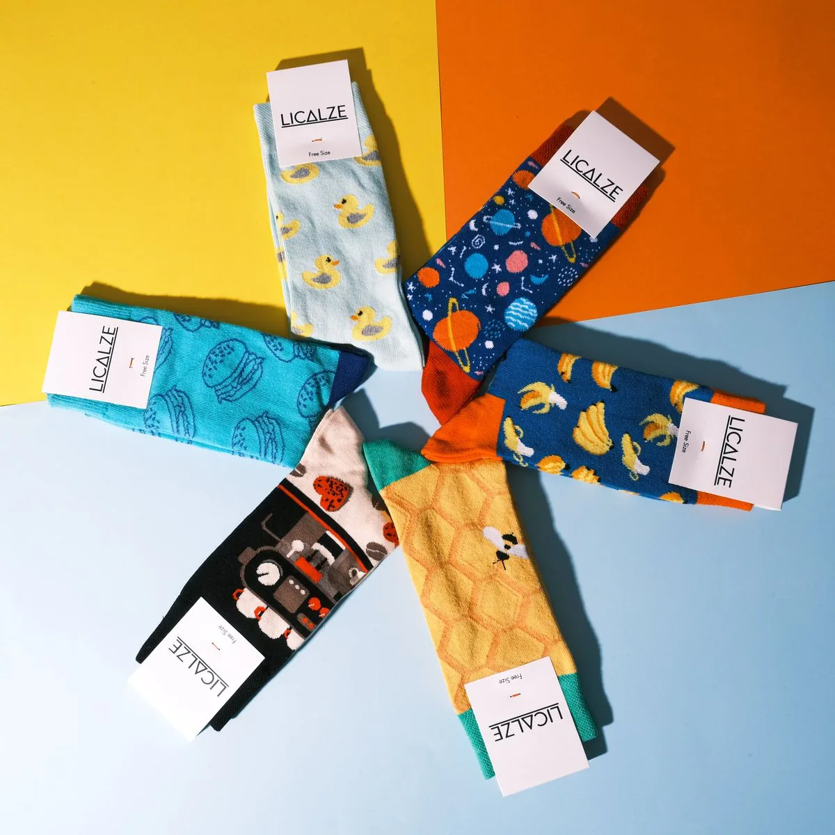 A vibrant collection of patterned socks displayed on a geometric colorful backdrop.